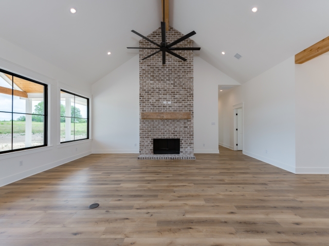 Living room with brick fireplace in the Wright Project by LaFollette Custom Homes.