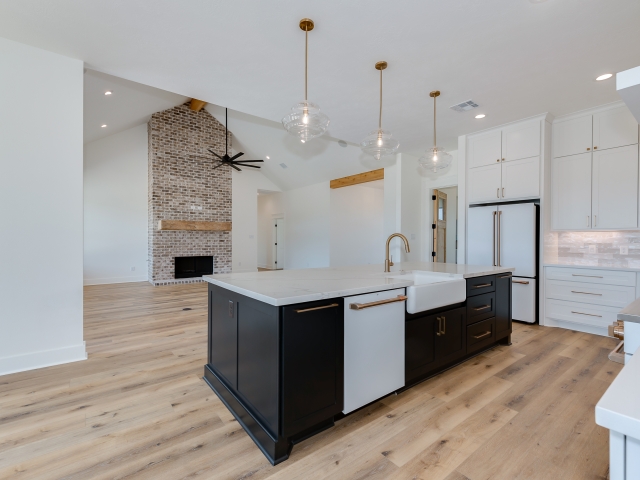 Wright Project kitchen by LaFollette Custom Homes featuring black and white cabinets.
