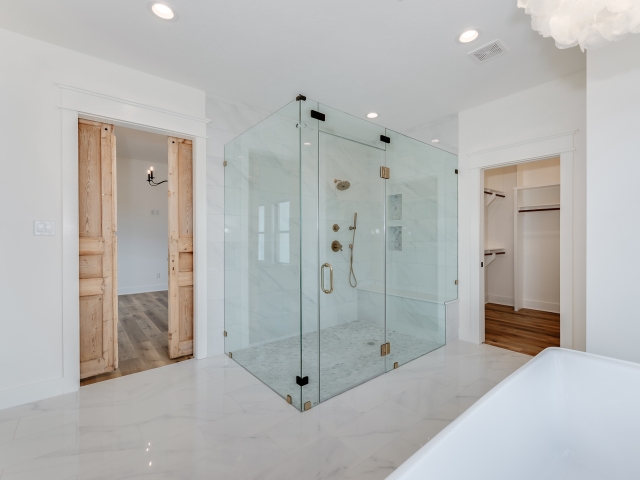 The Wright Project&#039;s master bath with glass shower by LaFollette Custom Homes.