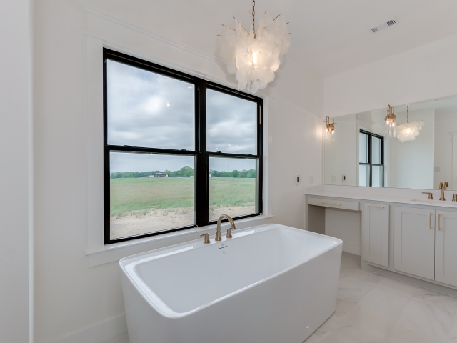 Master bath of the Wright Project with large tub and windows.