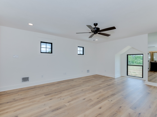 LaFollette Custom Homes bedroom with black accents and wood flooring.