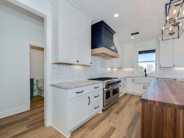 Kitchen of the Debarba Project by LaFollette Custom Homes with beautiful wood island.
