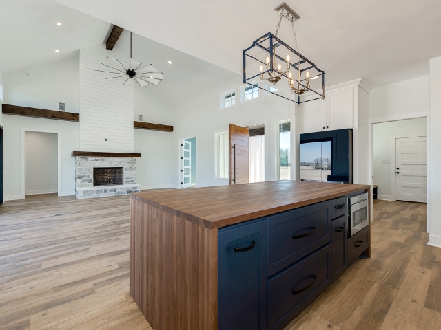 Kitchen and living room of the DeBarba Custom Home with stunning blue cabinets.