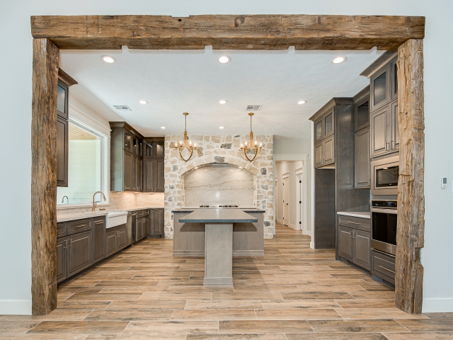 Kitchen of the Ball Circle Project by LaFollette Custom Homes with wood frame entry.