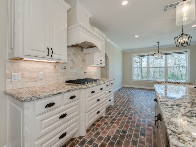 Kitchen of the Taylor Project by LaFollette Custom Homes with marble countertops.