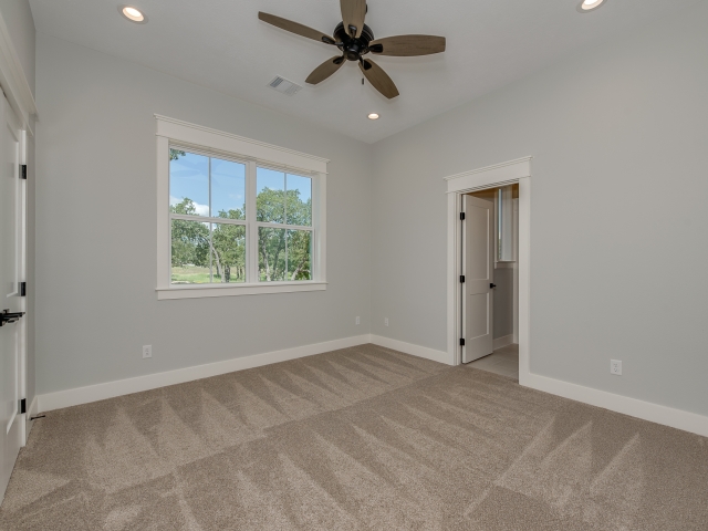 Bedroom of a LaFollette Custom Home with stunning windows.