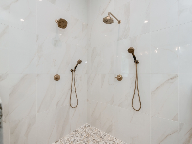 White marble shower of the Ball Circle Project by LaFollette Custom Homes.