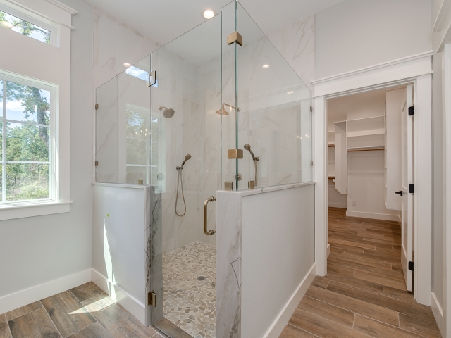 The Ball Circle Project&#039;s master shower with gold accents.
