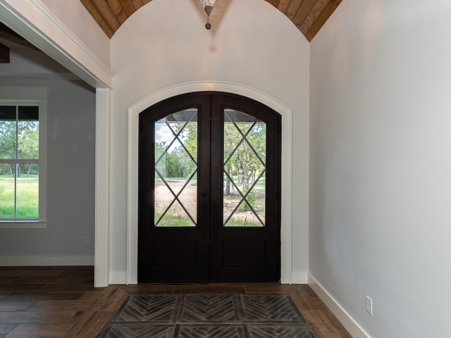 Foyer of the Ball Circle Project by LaFollette Custom Homes with stunning black doors.