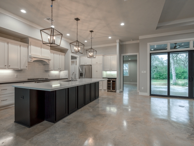 Kitchen of the Roznovsky Project by LaFollette Custom Homes with concrete flooring.