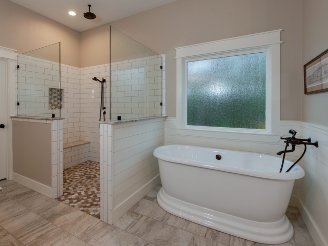Master bath of the Moore Project by LaFollette Custom Homes with shower and bathtub.