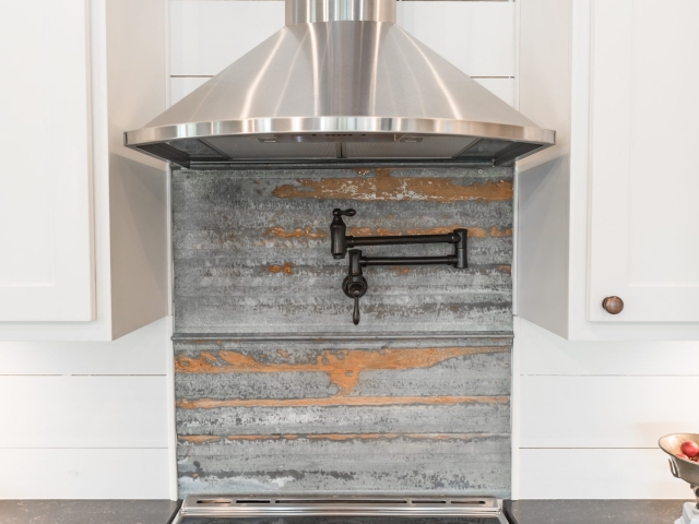 Stovetop and range hood from the Chisam Project by LaFollette Custom Homes.