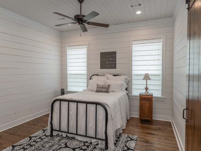 Bedroom with sliding barn door and modern farmhouse look.