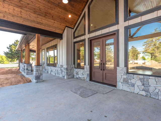 Grey stone and black trim are featured on the rear porch of the Millican Project.