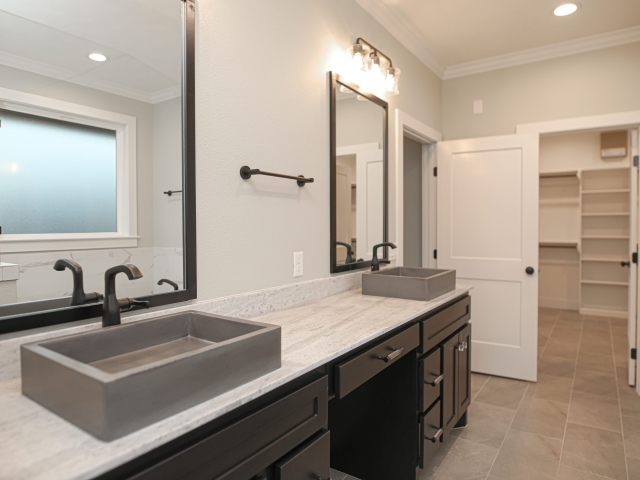 Master bath of the Atnip Project with grey sinks.