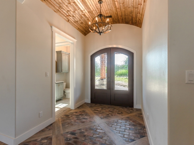 Foyer of the Millican Project by LaFollette Custom Homes with brick and wood flooring.