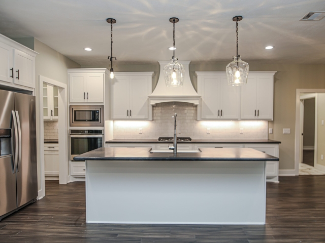Atnip Project by LaFollette Custom Homes featuring large island and white cabinets.