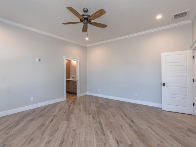 LaFollette Custom Homes bedroom with wood flooring.