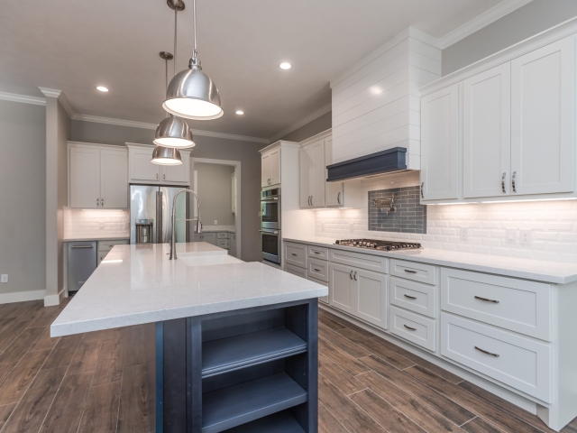 Kitchen of the Bishop Project by LaFollette Custom Homes with blue cabinet details.