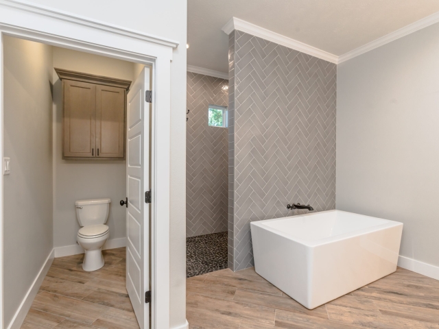 Master bathroom of the Millican Project by LaFollette Custom homes, featuring grey accents.