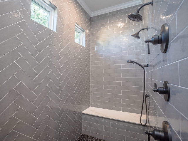 The Millican Project&#039;s master shower with grey tile.