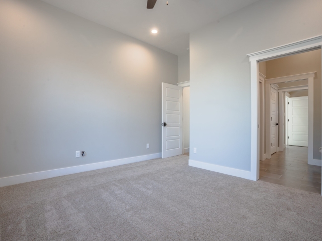 Bedroom with grey carpet.