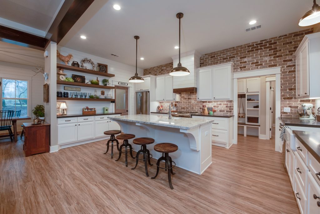 Custom built kitchen with built in shelves and large center island.