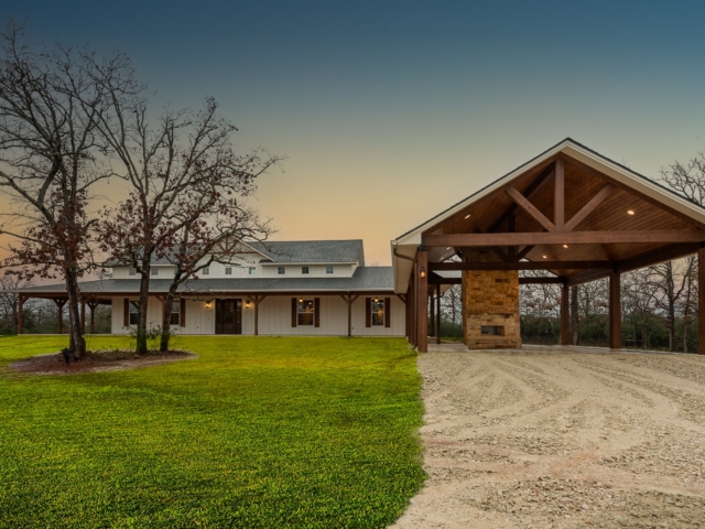 The Washburn Custom Home with white exterior and wood trim wrap-around porch.