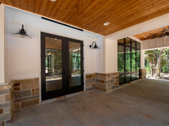 Stunning black trim and modern farmhouse back porch of the Torres Custom Home.