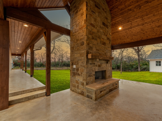 Stunning stone fireplace and carport of the Washburn Project.