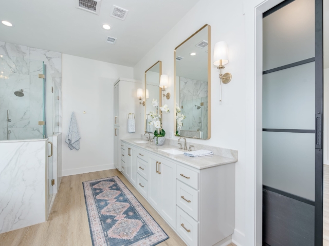 The Lakecrest Project&#039;s master bathroom with gold and marble details.