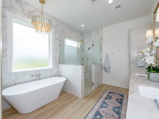Lakecrest Project&#039;s master bath with marble walls by LaFollette Custom Homes.