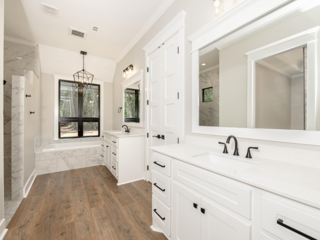 Master bath of the Torres Project by LaFollette Custom Homes with white cabinets.