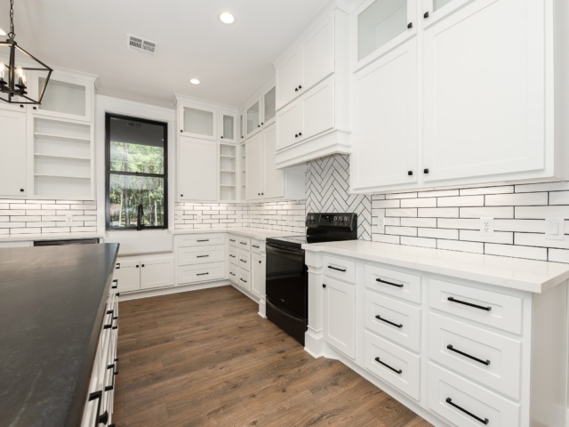 White kitchen with black accents from the Torres Project by LaFollette Custom Homes.