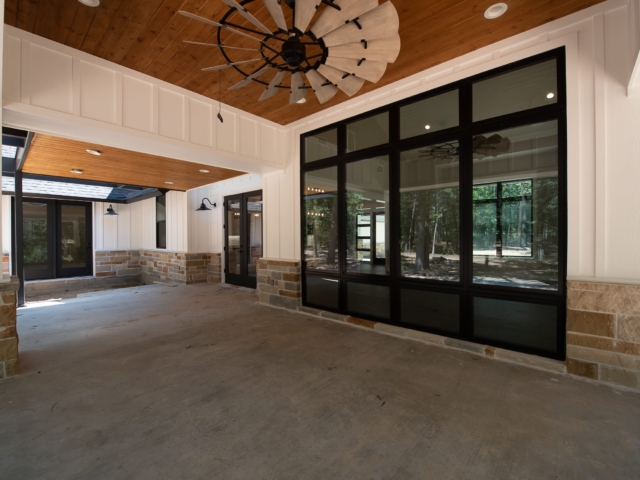 Rear porch of the Torres Custom Home with white and stone accents.