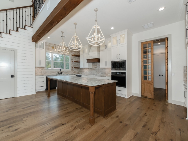 Kitchen of the Hovey Project by LaFollette Custom Homes with wood and marble island.