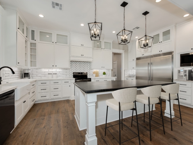 Kitchen of the Torres Project by LaFollette Custom Homes featuring white cabinets.
