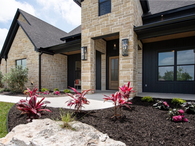 The Lakecrest Project by LaFollette Custom Homes with dark accents and landscaping.